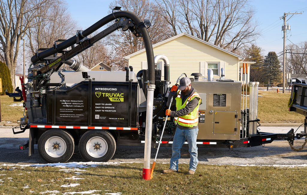 A hydrovac operator safe digging using Truvac TRXX in a community neighborhood 